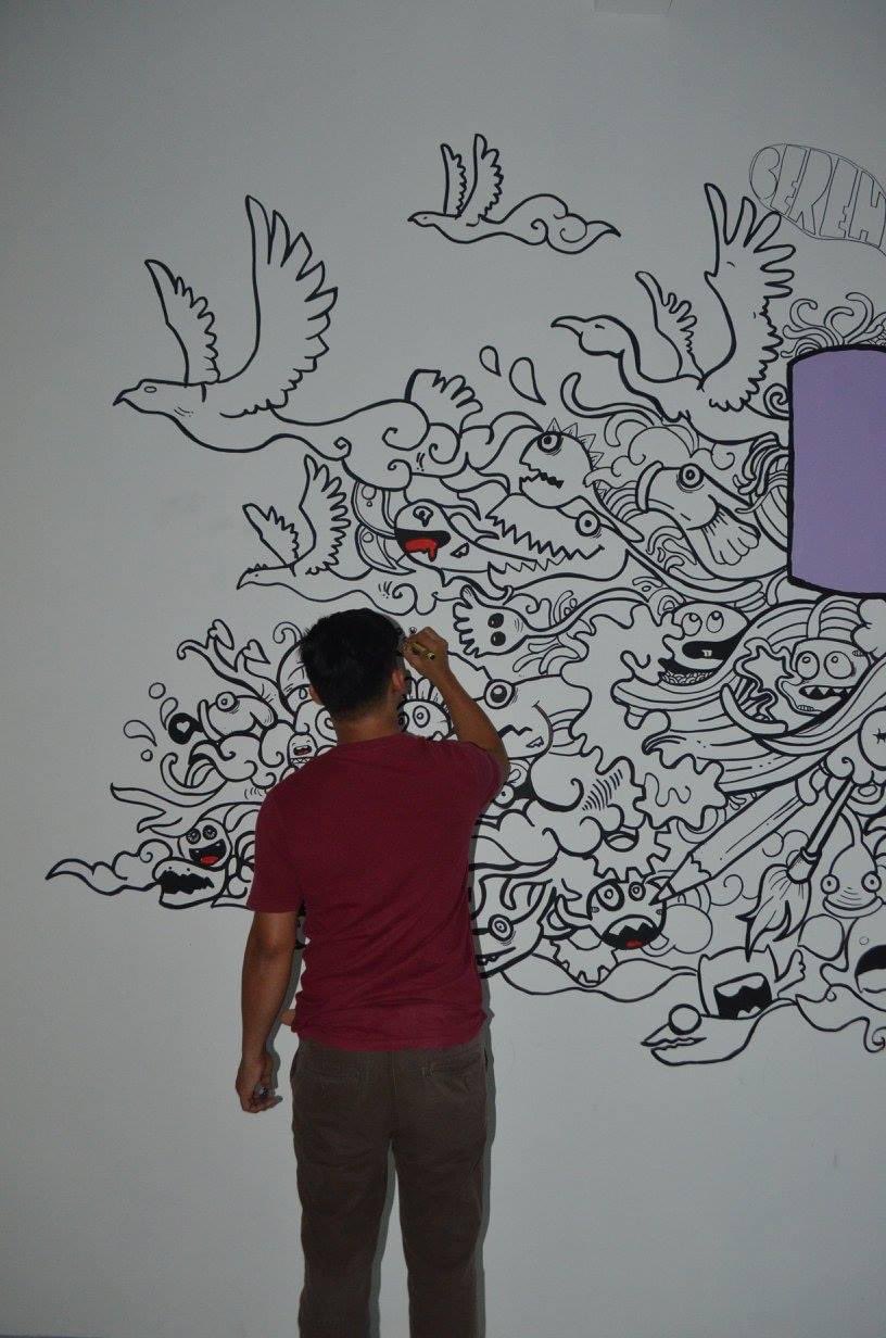 Rex creating a mural